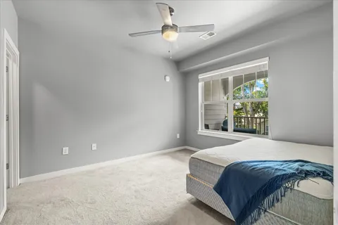 a bedroom with a large bed and a window