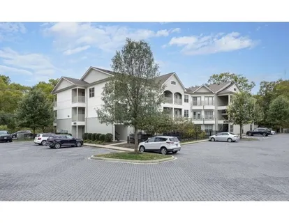a car parked in front of a white house