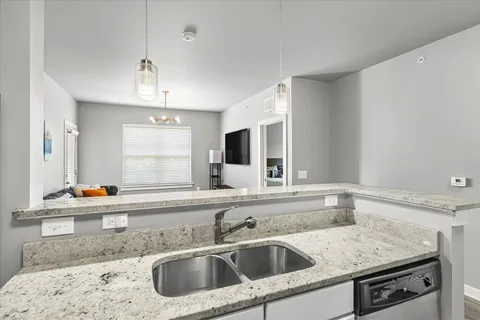 a kitchen with a sink and a refrigerator