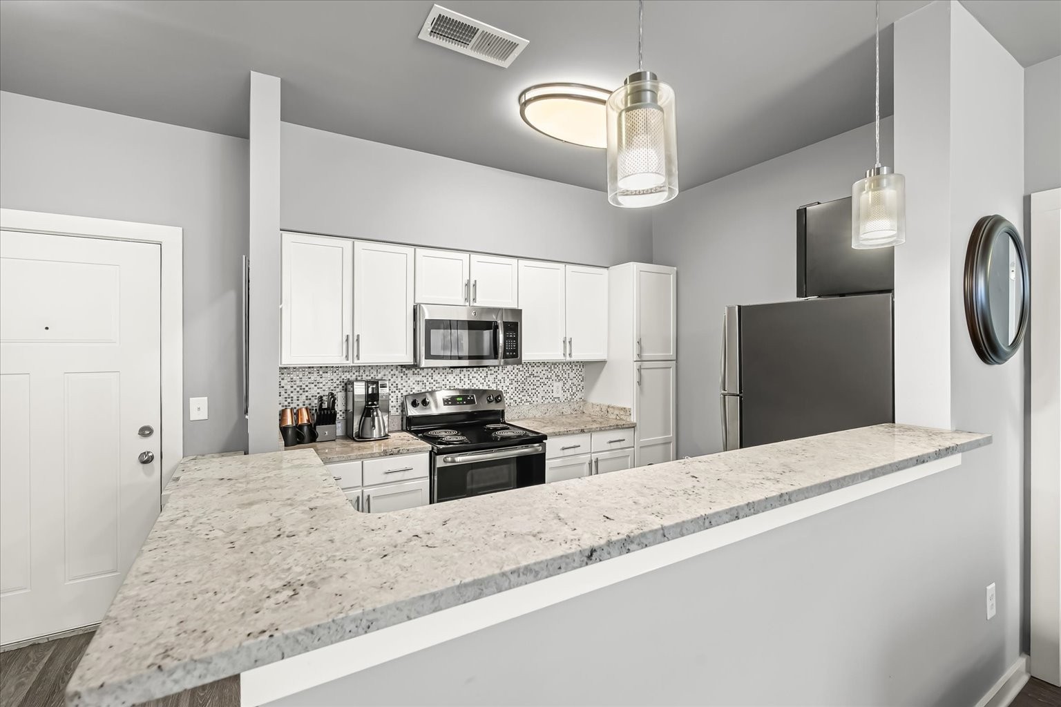 414 Rosedale Avenue, Unit 301 Nashville, TN 37211 - Photo 8 of 21 a kitchen with stainless steel appliances granite countertop a sink a stove top oven a refrigerator and a granite counter tops