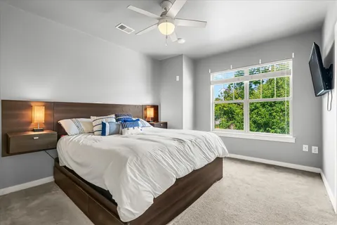 a bedroom with a bed and a tv