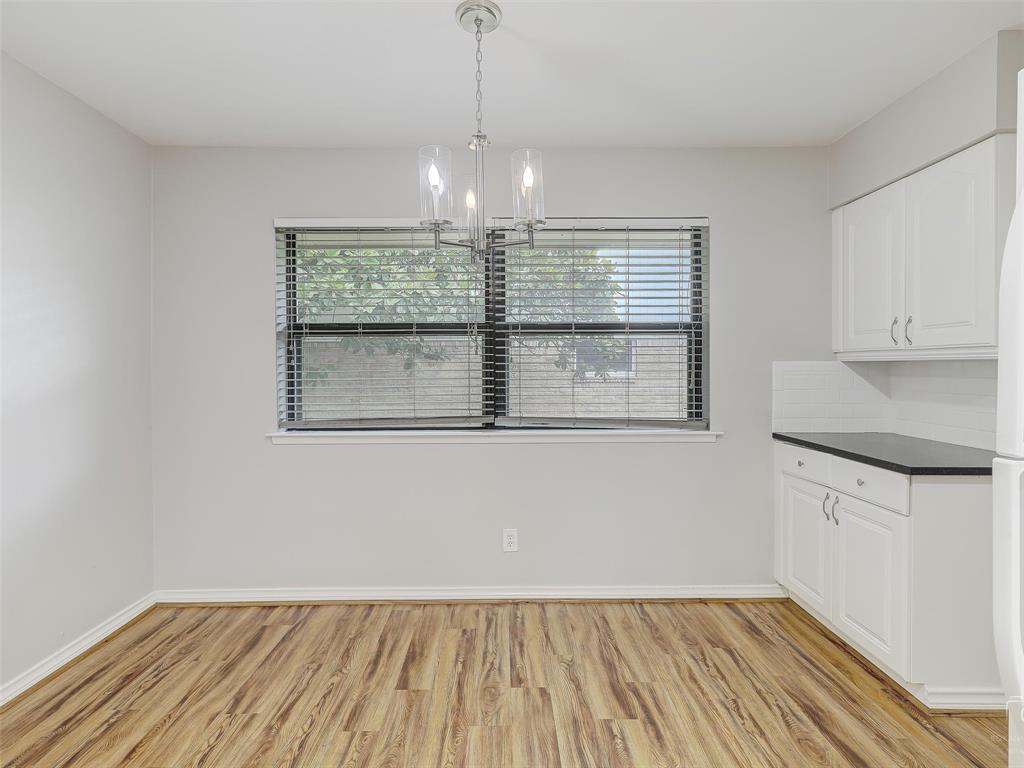 4079 Calculus Drive Dallas, TX 75244 - Photo 11 of 26 a view of an empty room with a window and wooden floor