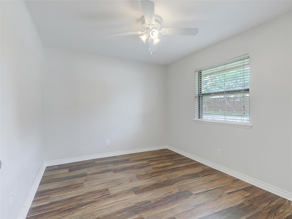 4079 Calculus Drive Dallas, TX 75244 - Photo 20 of 26 a view of empty room with wooden floor and fan