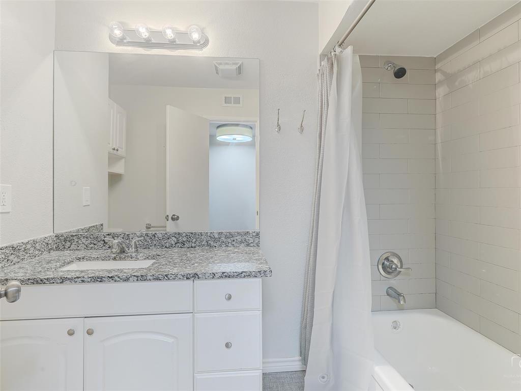 4079 Calculus Drive Dallas, TX 75244 - Photo 21 of 26 a bathroom with a granite countertop sink and mirror with bathtub