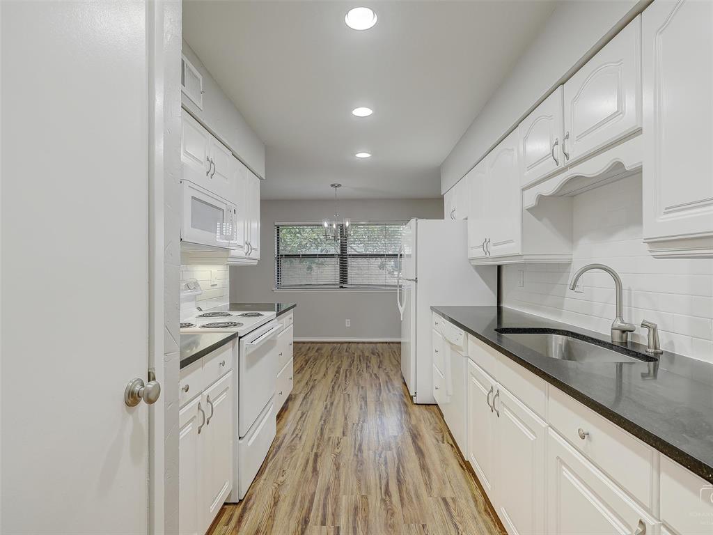 4079 Calculus Drive Dallas, TX 75244 - Photo 9 of 26 a large kitchen with a sink and cabinets