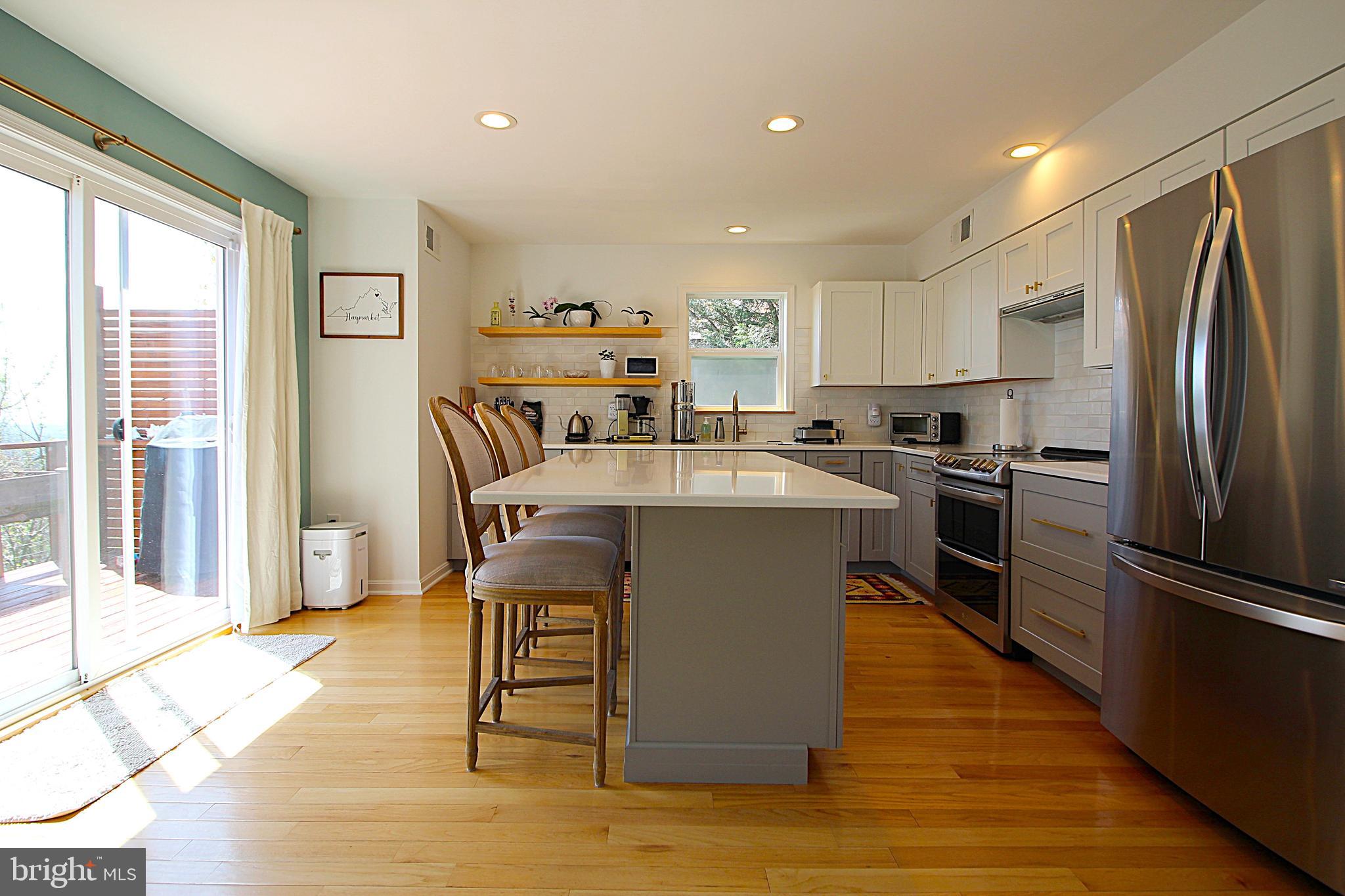 2602 Lookout Road Haymarket, VA 20169 - Photo 3 of 32 a kitchen with kitchen island a counter top space a sink stainless steel appliances and cabinets