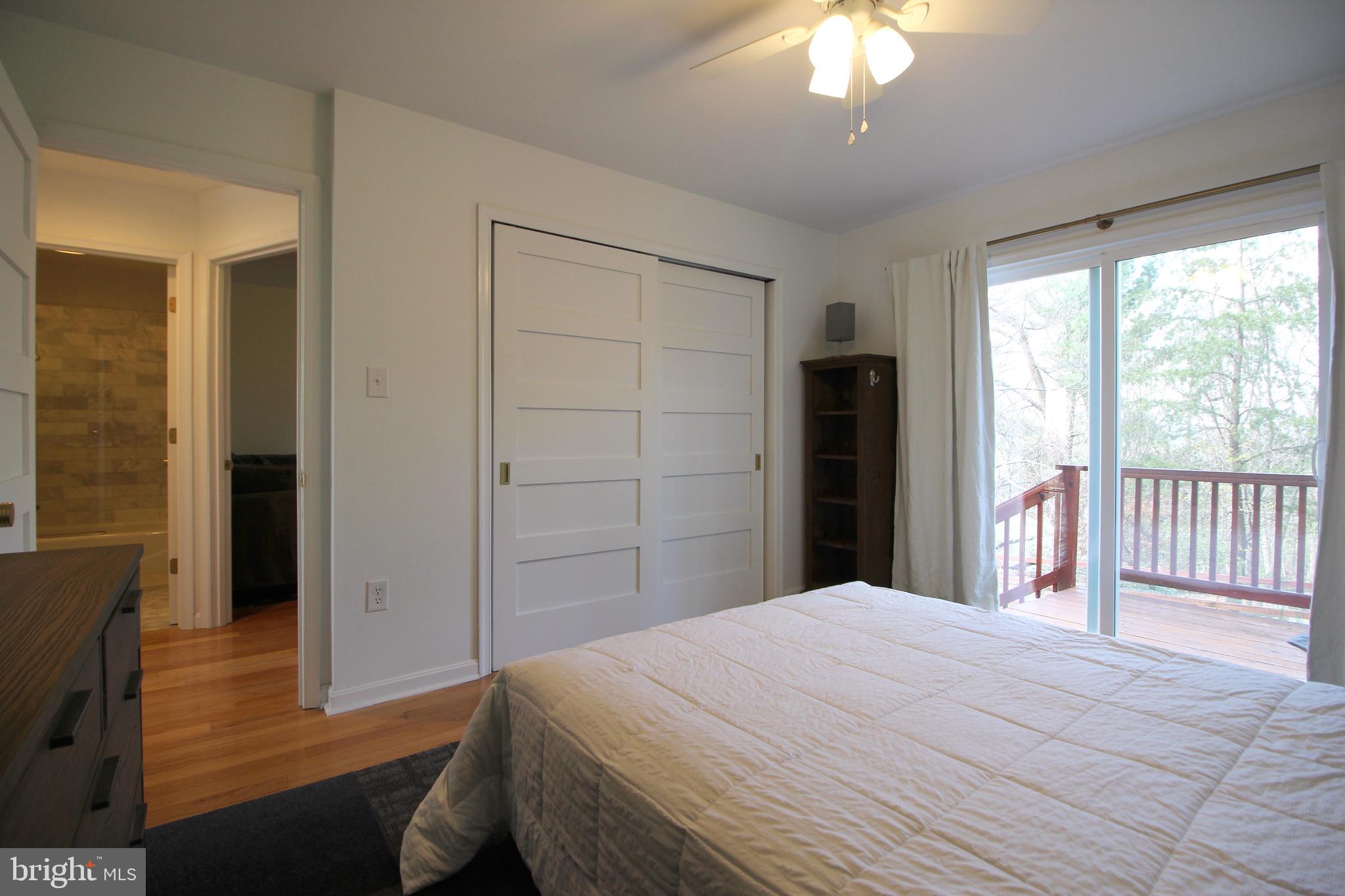 2602 Lookout Road Haymarket, VA 20169 - Photo 8 of 32 a bedroom with a large bed and a chandelier