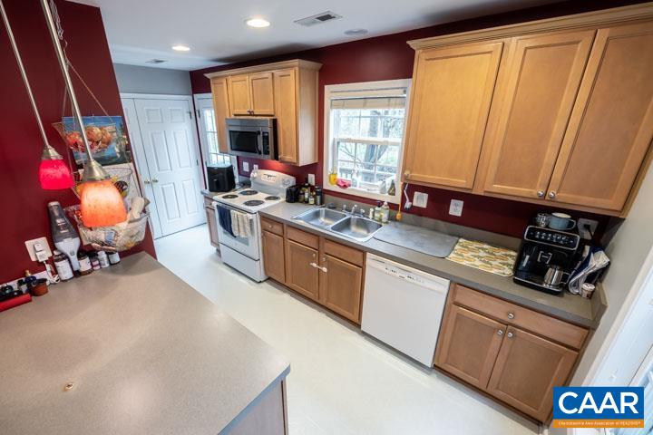 100 Roy's Place Charlottesville, VA 22902 - Photo 12 of 29 a kitchen with stainless steel appliances granite countertop refrigerator sink and wooden cabinets