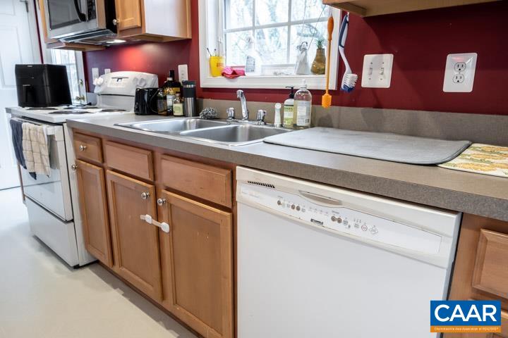 100 Roy's Place Charlottesville, VA 22902 - Photo 14 of 29 a kitchen with stainless steel appliances granite countertop a sink and a microwave