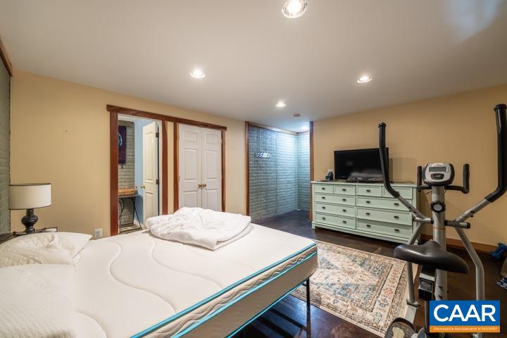 100 Roy's Place Charlottesville, VA 22902 - Photo 26 of 29 a bedroom with a bed and wooden floor