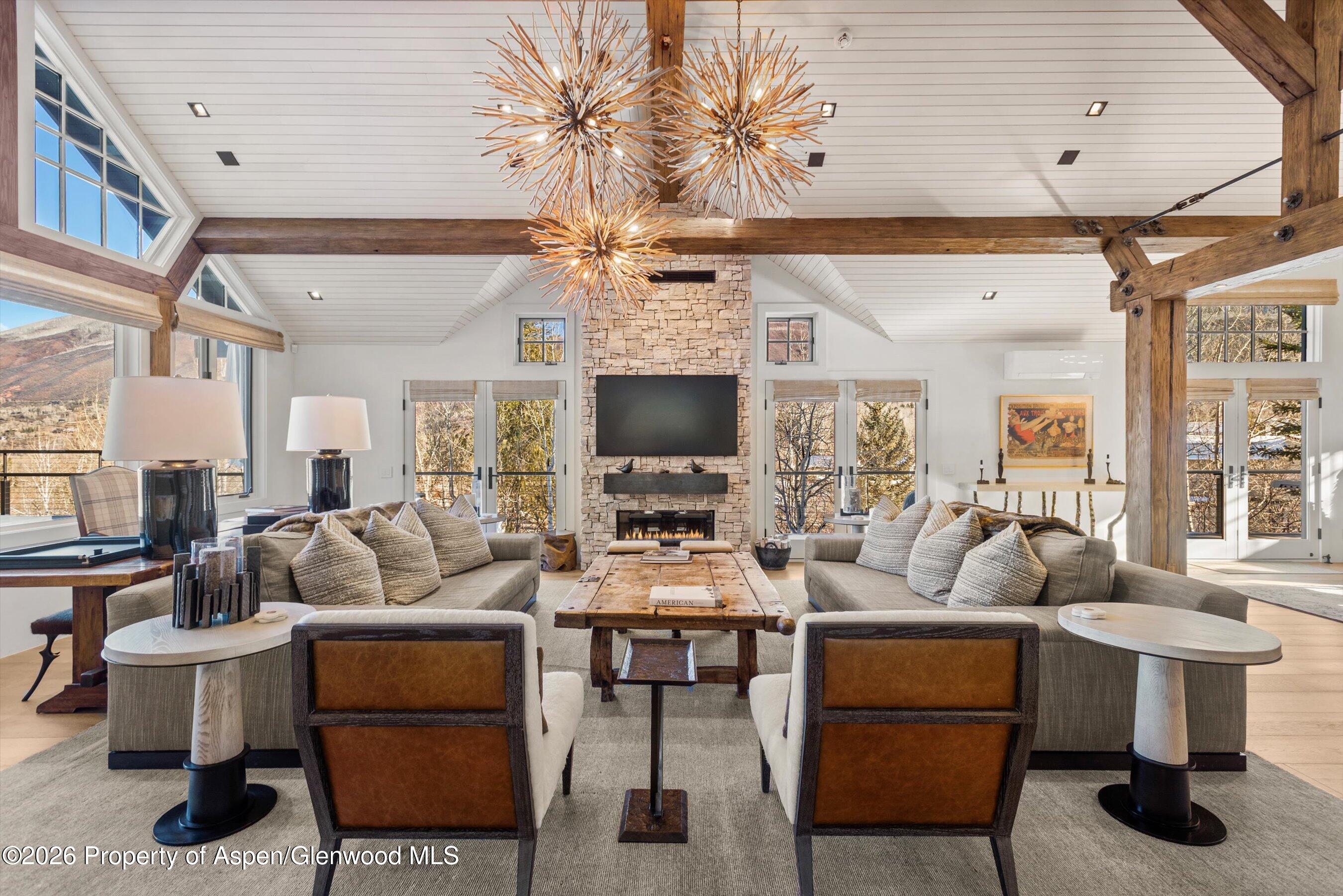 1271 Ute Avenue Aspen, CO 81611 - Photo 2 of 53 a living room with furniture a flat screen tv and a chandelier