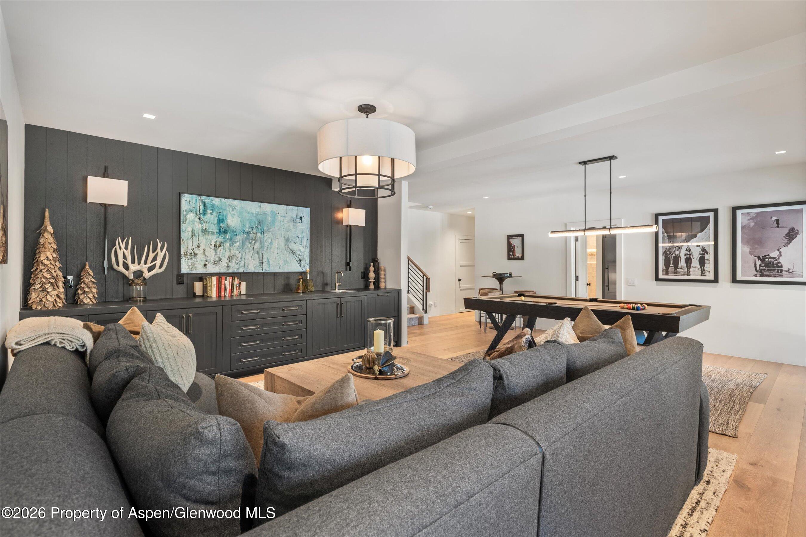1271 Ute Avenue Aspen, CO 81611 - Photo 21 of 53 a living room with furniture and a chandelier