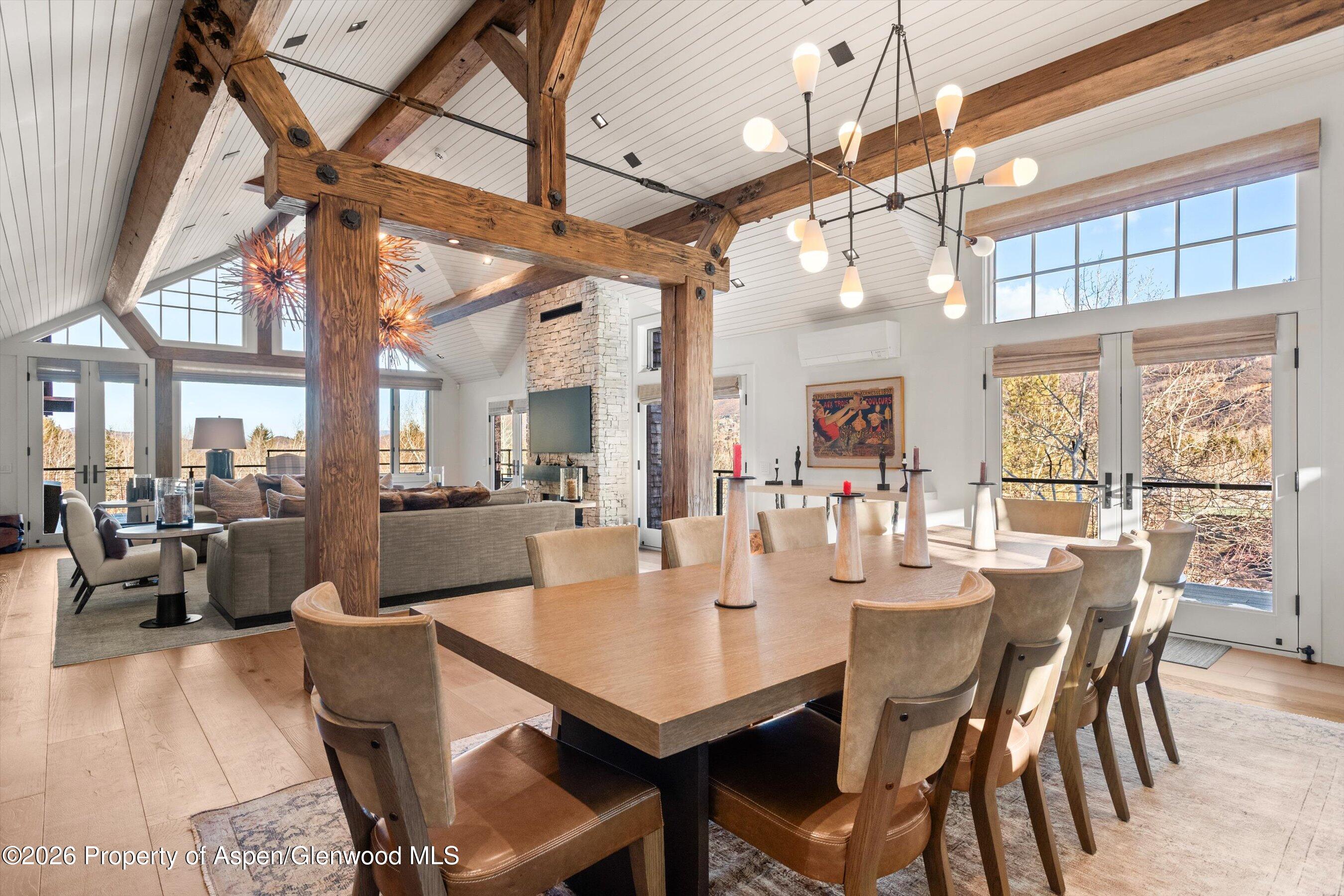 1271 Ute Avenue Aspen, CO 81611 - Photo 6 of 53 a dining room with wooden floor a chandelier a wooden table and chairs