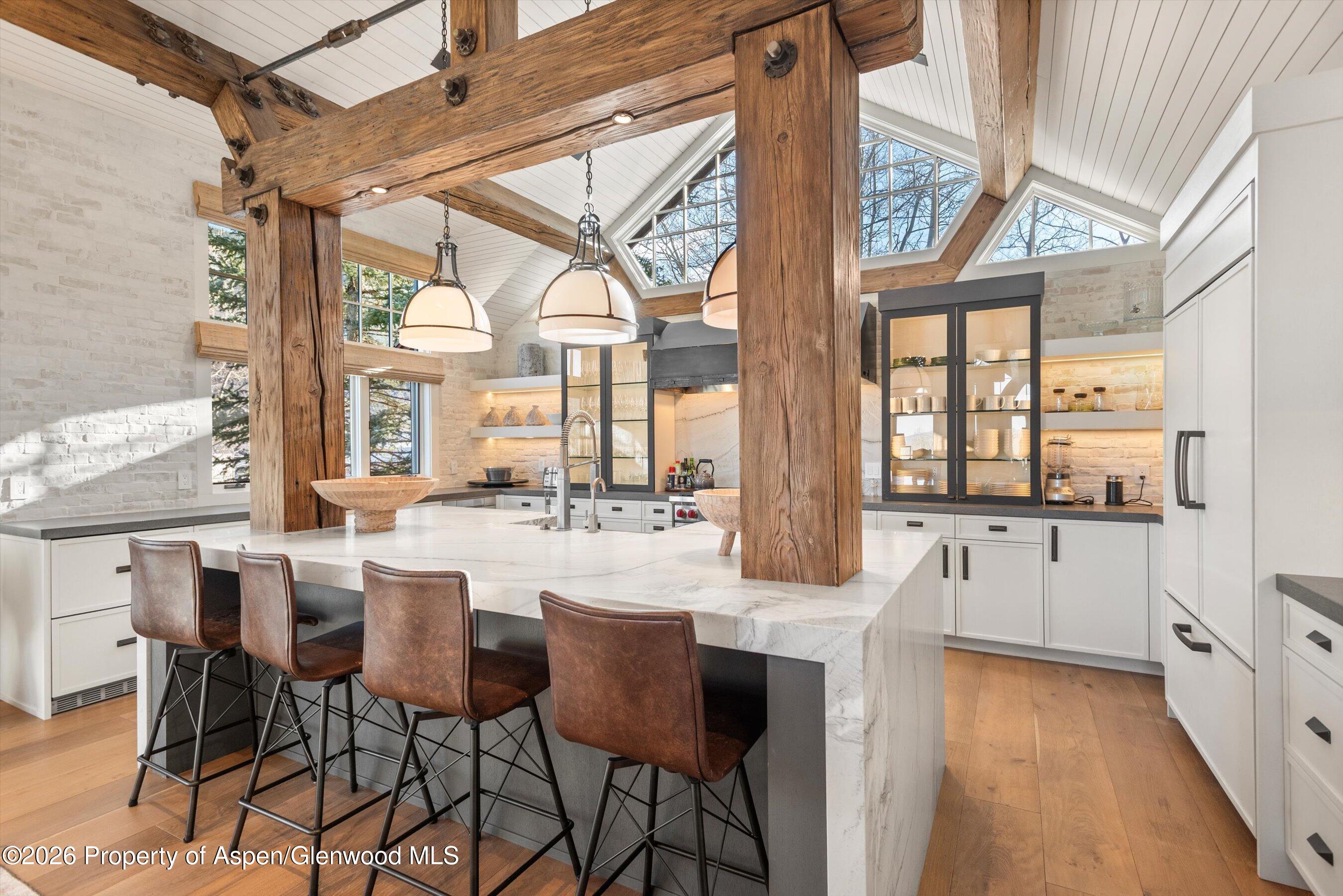 1271 Ute Avenue Aspen, CO 81611 - Photo 8 of 53 a view of a dining room with furniture large windows a chandelier and wooden floor