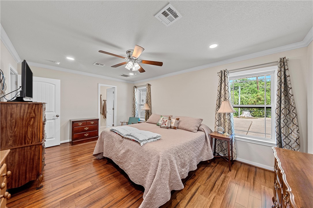 1929 Trinity Drive Waco, TX 76710 - Photo 11 of 22 a spacious bedroom with a bed and a chandelier