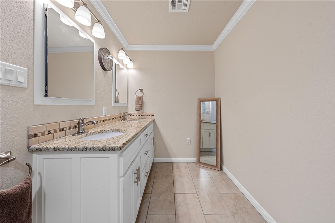 1929 Trinity Drive Waco, TX 76710 - Photo 12 of 22 a bathroom with a granite countertop sink and a mirror