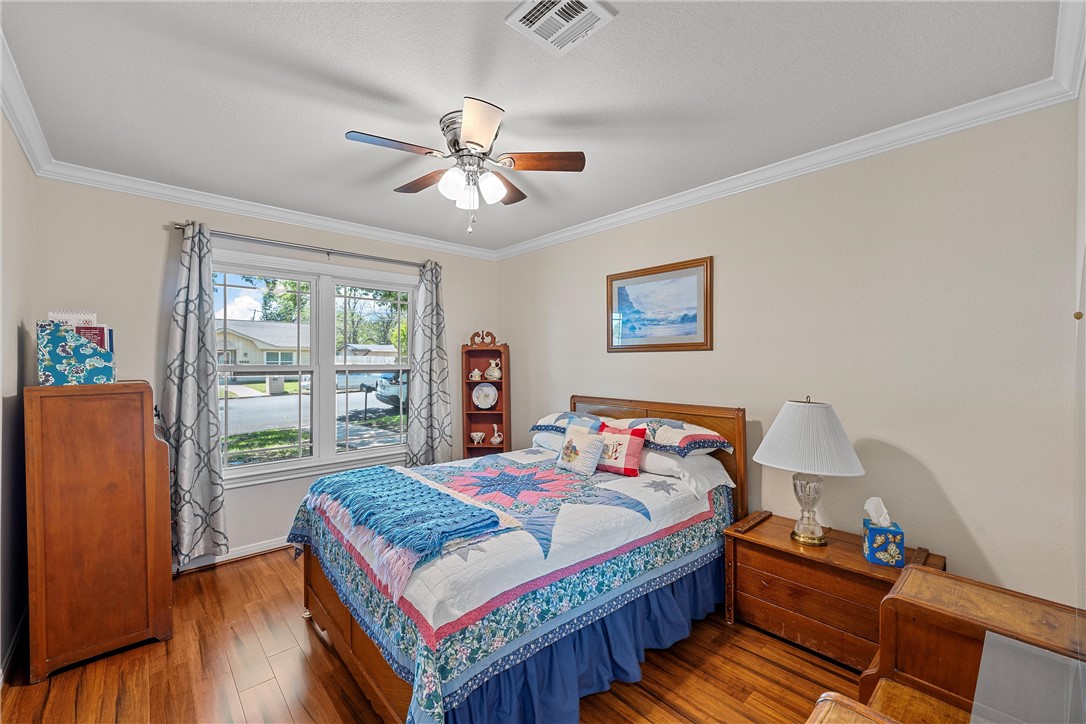 1929 Trinity Drive Waco, TX 76710 - Photo 14 of 22 a bedroom with a bed and wooden floor