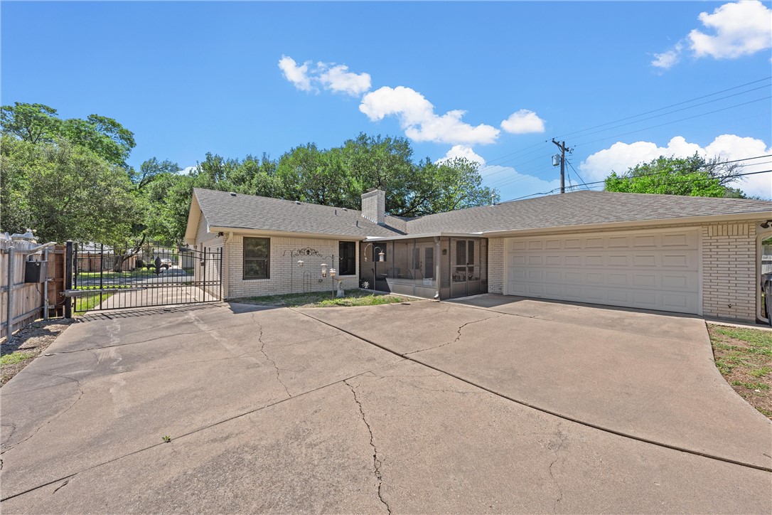1929 Trinity Drive Waco, TX 76710 - Photo 20 of 22 a front view of a house with a yard and a garage
