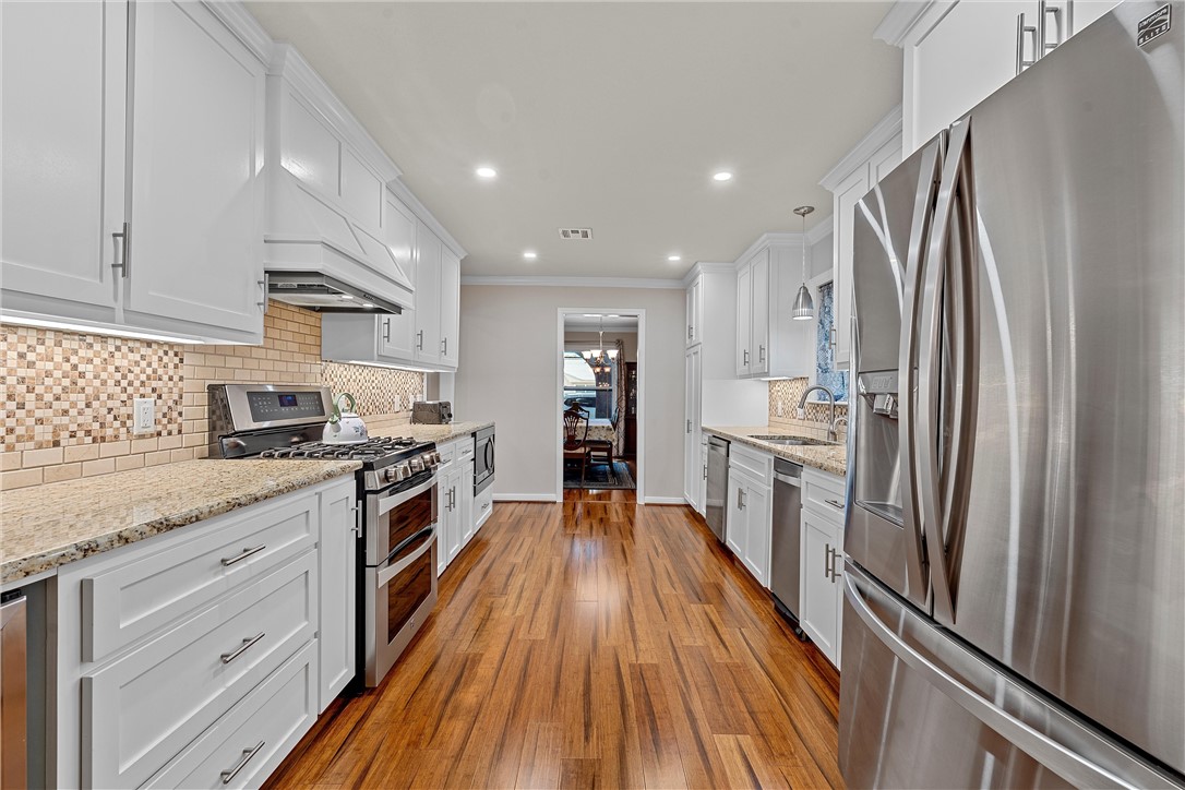 1929 Trinity Drive Waco, TX 76710 - Photo 6 of 22 a kitchen with granite countertop stainless steel appliances a refrigerator stove top oven and sink