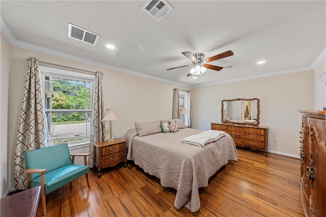 1929 Trinity Drive Waco, TX 76710 - Photo 10 of 22 a bedroom with a bed and wooden floor
