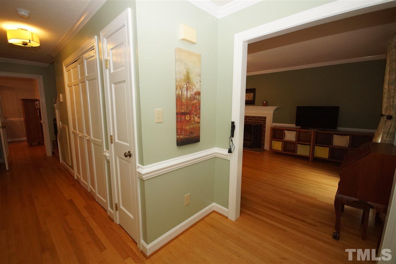 7033 Sandringham Court Raleigh, NC 27613 - Photo 2 of 25 a view of a living room with furniture and wooden floor