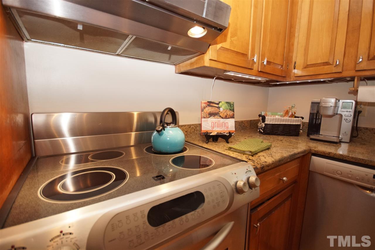 7033 Sandringham Court Raleigh, NC 27613 - Photo 11 of 25 a kitchen with appliances a sink and a stove