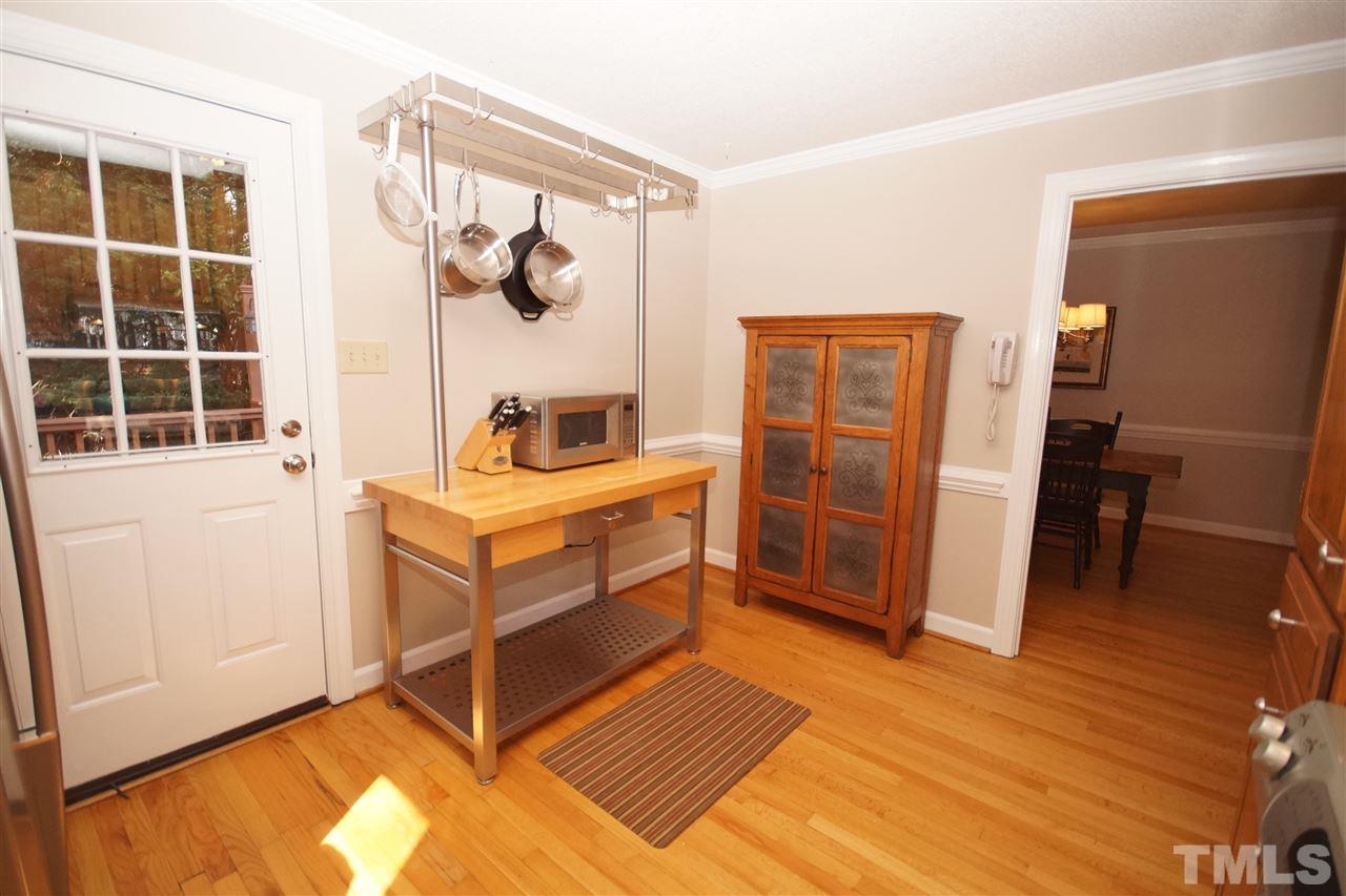7033 Sandringham Court Raleigh, NC 27613 - Photo 12 of 25 a room with furniture and wooden floor