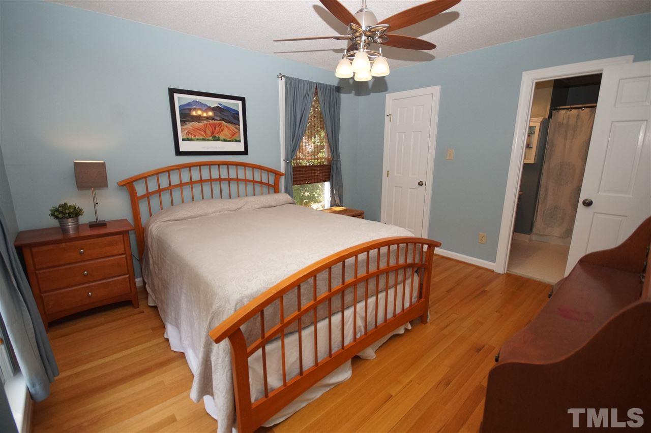 7033 Sandringham Court Raleigh, NC 27613 - Photo 13 of 25 a bedroom with a bed and a window