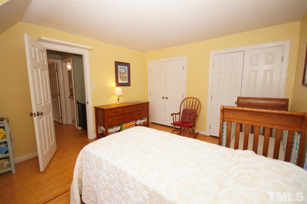 7033 Sandringham Court Raleigh, NC 27613 - Photo 17 of 25 a bedroom with a bed and a window