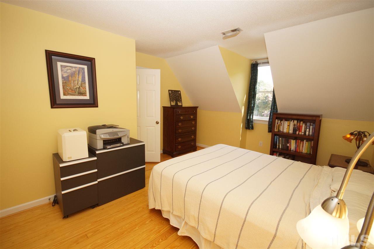 7033 Sandringham Court Raleigh, NC 27613 - Photo 19 of 25 a bedroom with a bed and a television