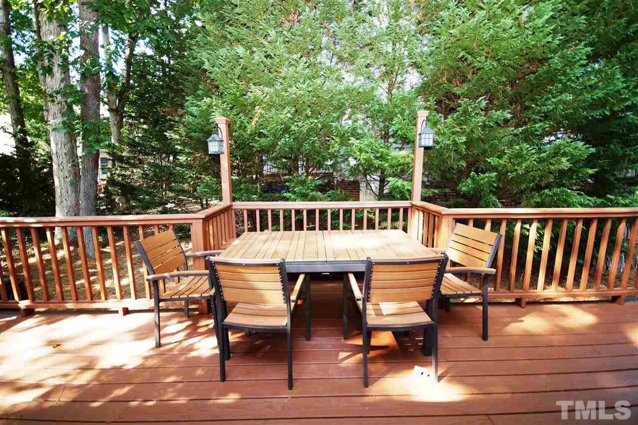 7033 Sandringham Court Raleigh, NC 27613 - Photo 22 of 25 a view of a chairs and table on the deck