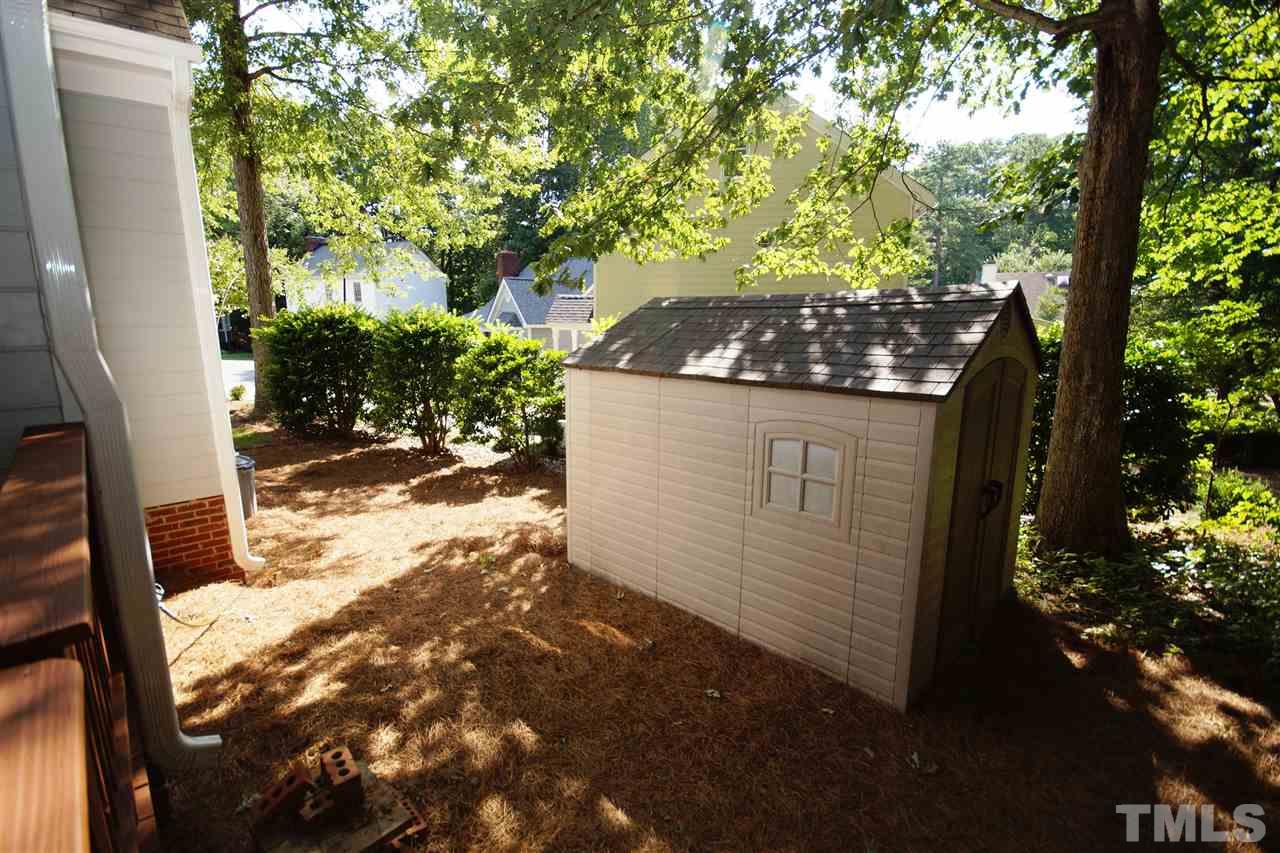7033 Sandringham Court Raleigh, NC 27613 - Photo 23 of 25 a view of a yard in front of a house with a tree