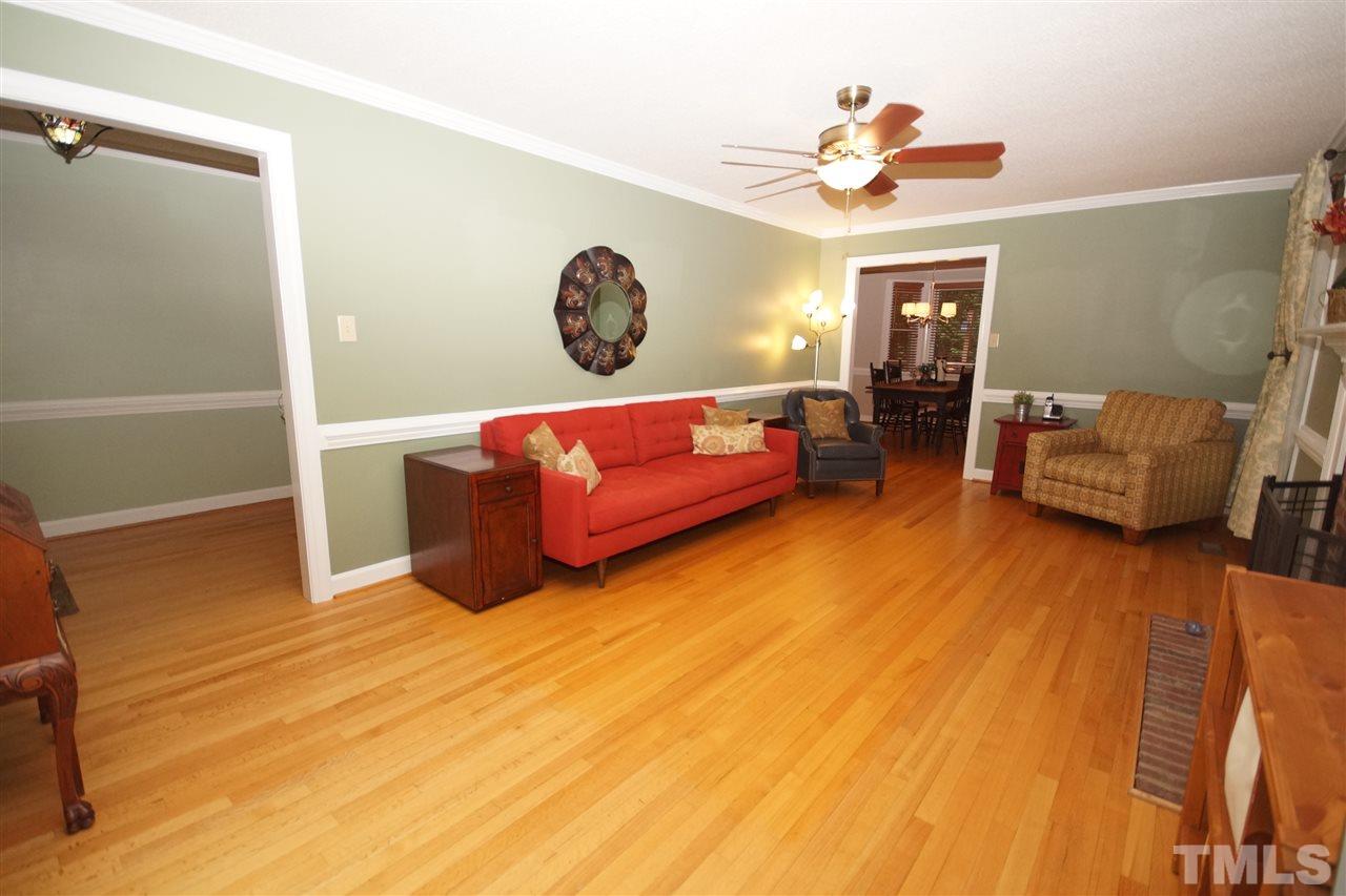 7033 Sandringham Court Raleigh, NC 27613 - Photo 4 of 25 a living room with furniture and a flat screen tv