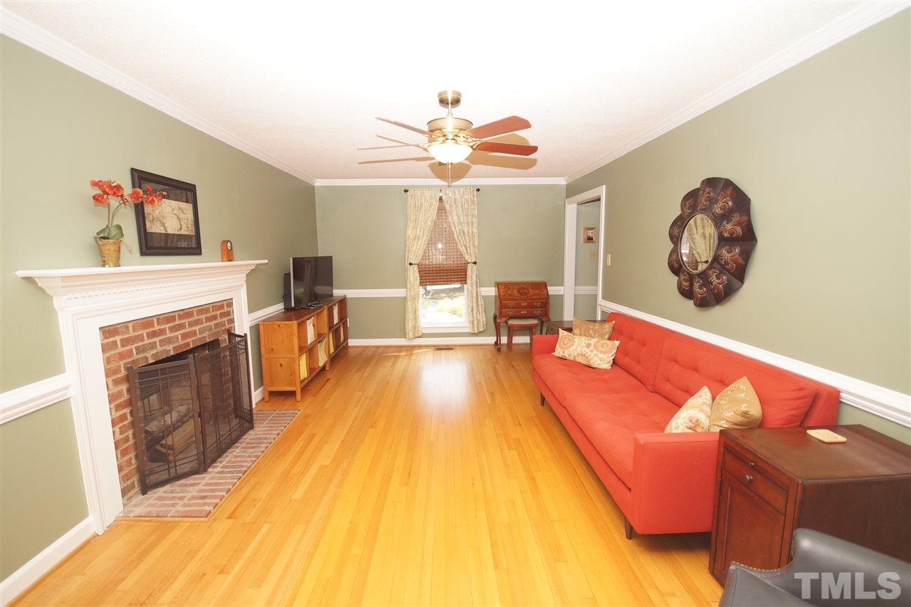 7033 Sandringham Court Raleigh, NC 27613 - Photo 6 of 25 a living room with furniture and a fireplace