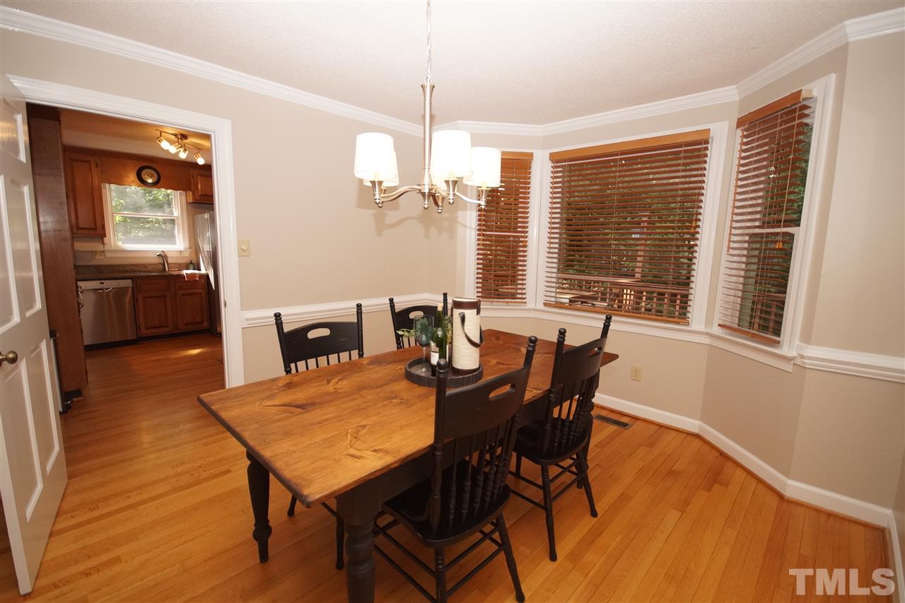 7033 Sandringham Court Raleigh, NC 27613 - Photo 8 of 25 a view of a dining room with furniture window and wooden floor