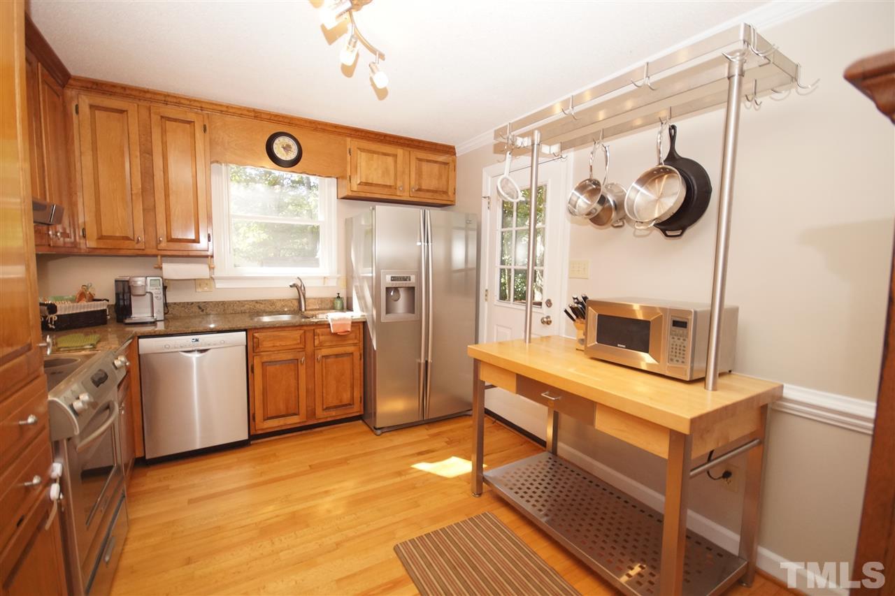 7033 Sandringham Court Raleigh, NC 27613 - Photo 10 of 25 a kitchen with cabinets and window