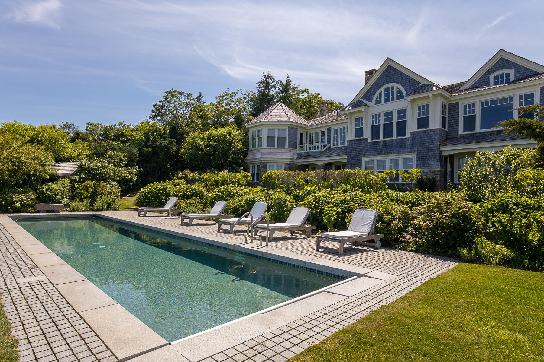7 Clay Pit Road Aquinnah, MA 02535 - Photo 27 of 29 a view of a house with pool lawn chairs and a yard