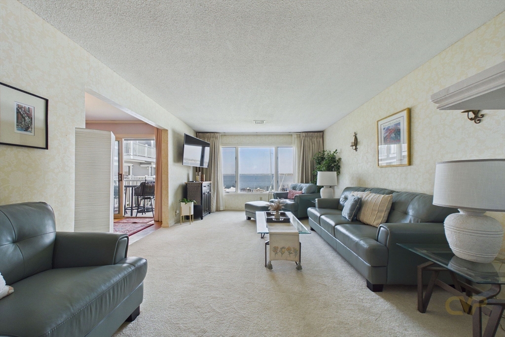 700 Shore Drive, Unit 509 Fall River, MA 02721 - Photo 6 of 25 a living room with furniture and a couch