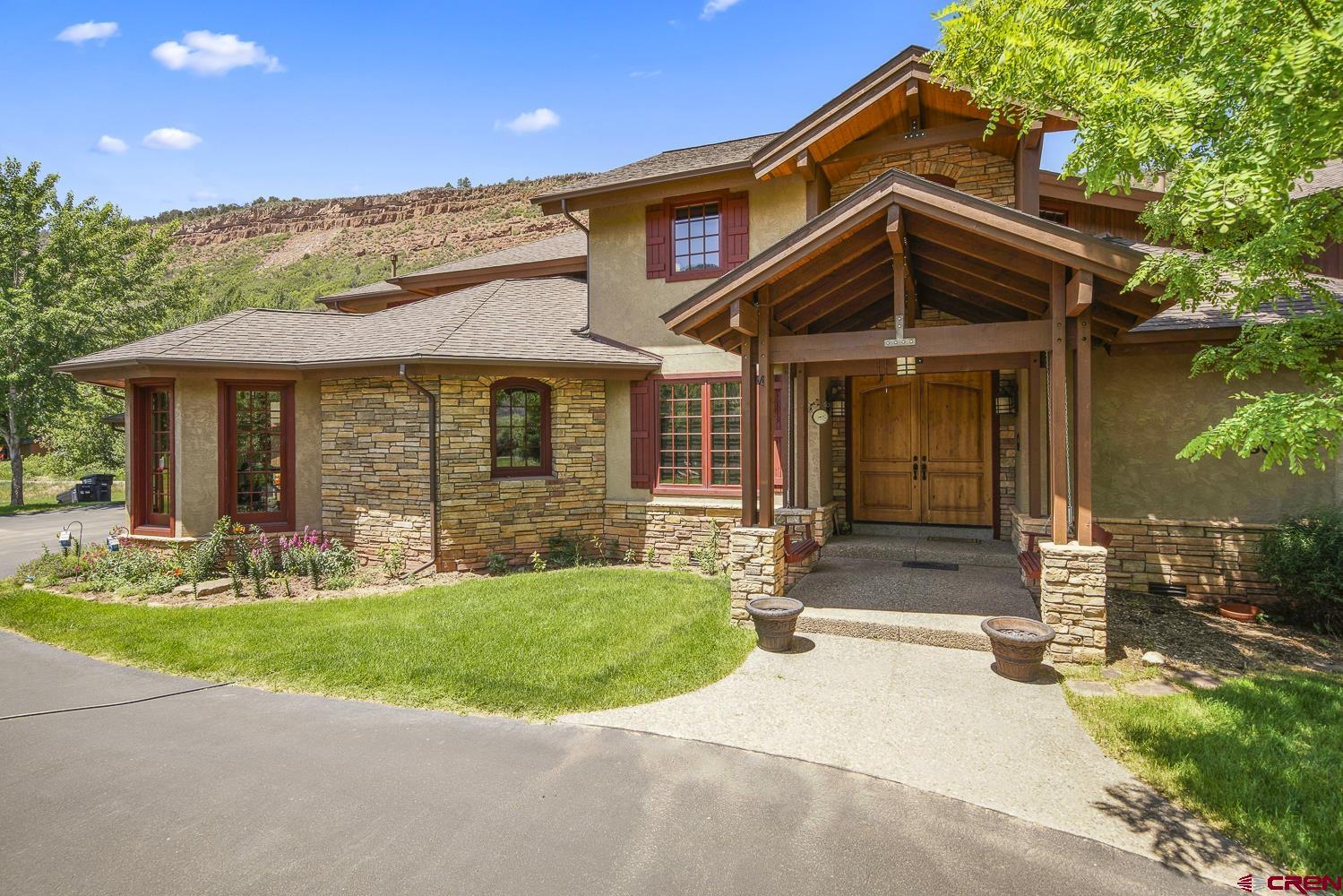 a front view of a house with a yard and porch