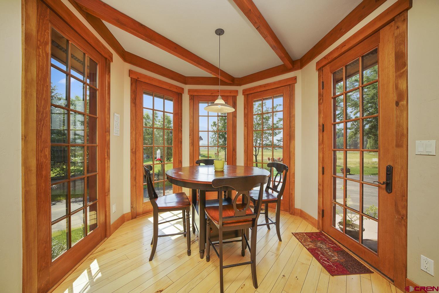 80 Twilight Trails Circle Durango, CO 81301 - Photo 12 of 26 a view of a dining room with furniture large windows and wooden floor