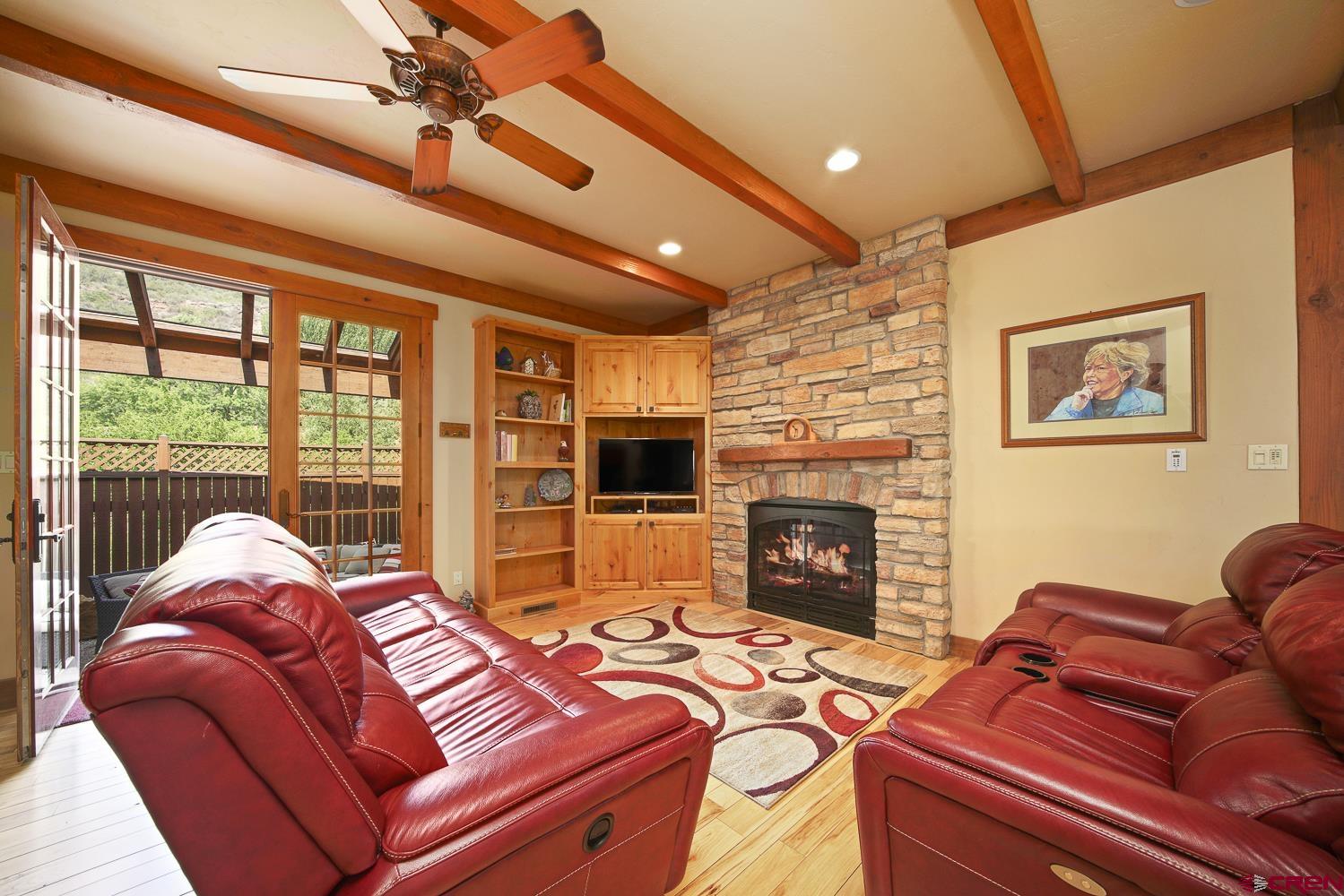 80 Twilight Trails Circle Durango, CO 81301 - Photo 15 of 26 a living room with furniture a fireplace and a flat screen tv