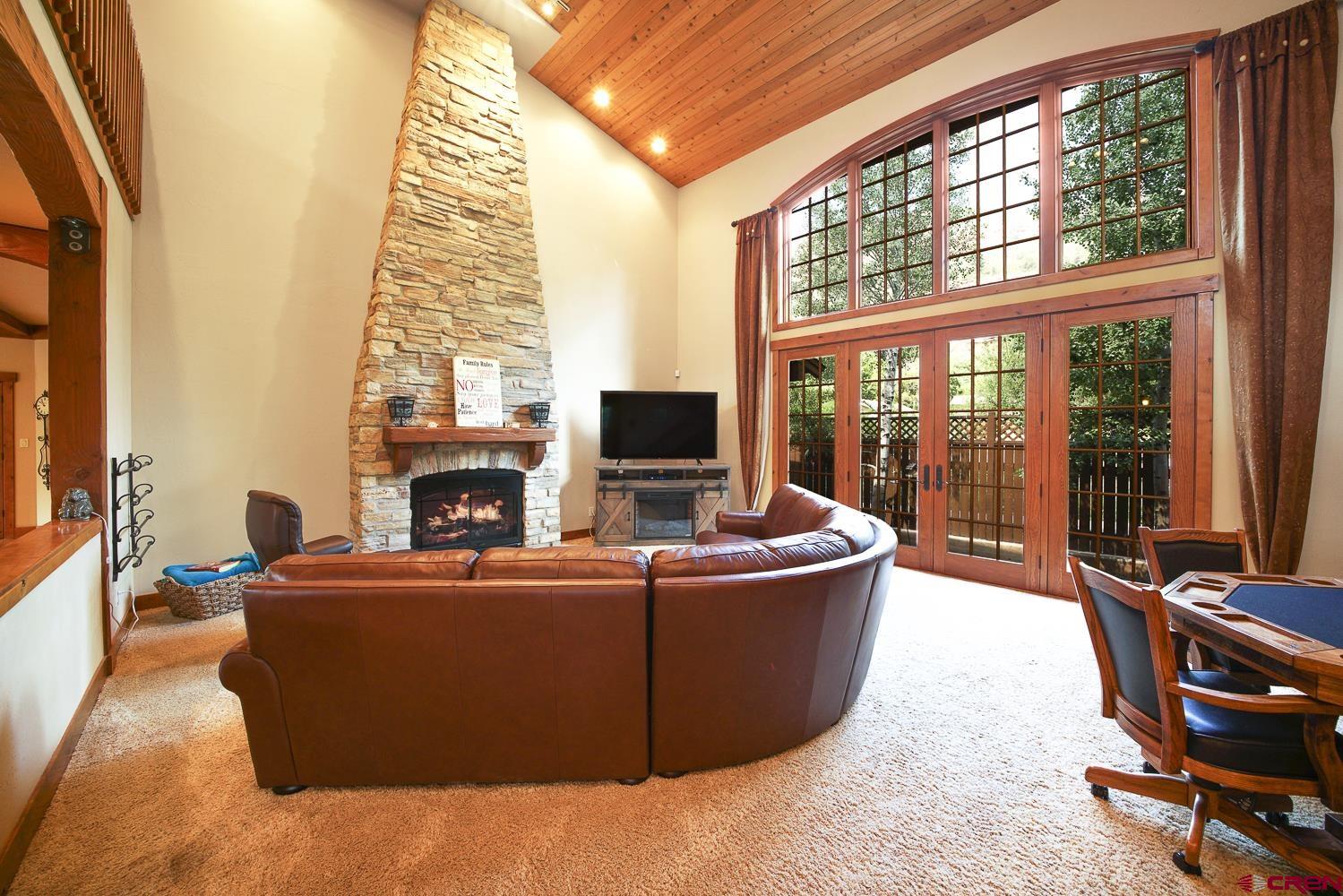 80 Twilight Trails Circle Durango, CO 81301 - Photo 16 of 26 a living room with furniture a fireplace and a flat screen tv