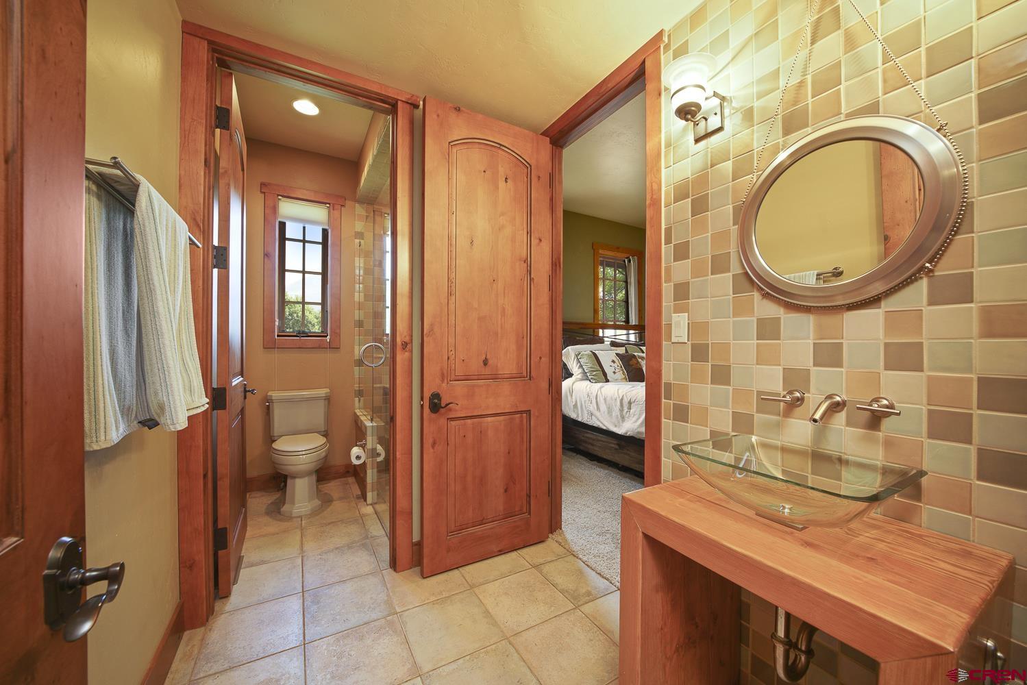 80 Twilight Trails Circle Durango, CO 81301 - Photo 22 of 26 a spacious bathroom with a granite countertop sink mirror vanity and toilet