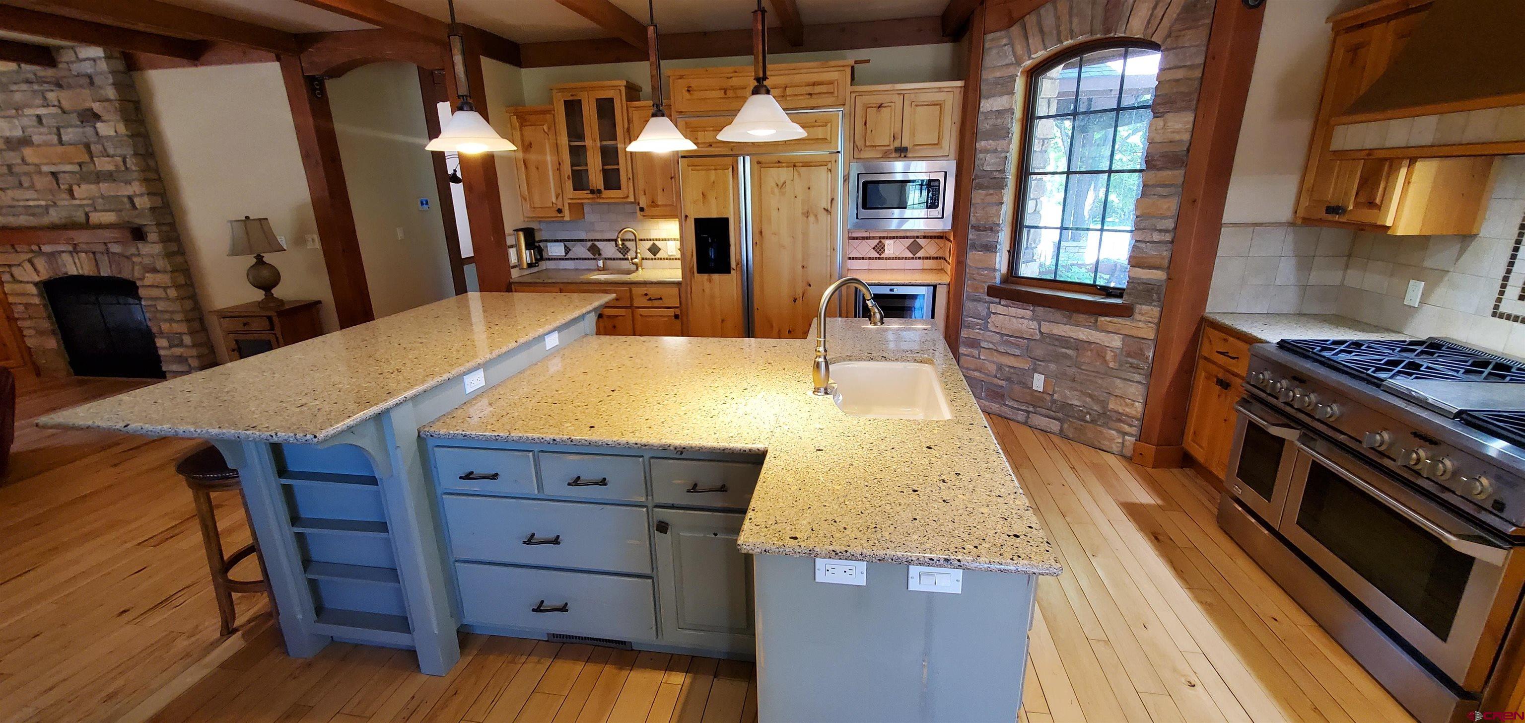 80 Twilight Trails Circle Durango, CO 81301 - Photo 7 of 26 a kitchen with a wooden floor and a stove