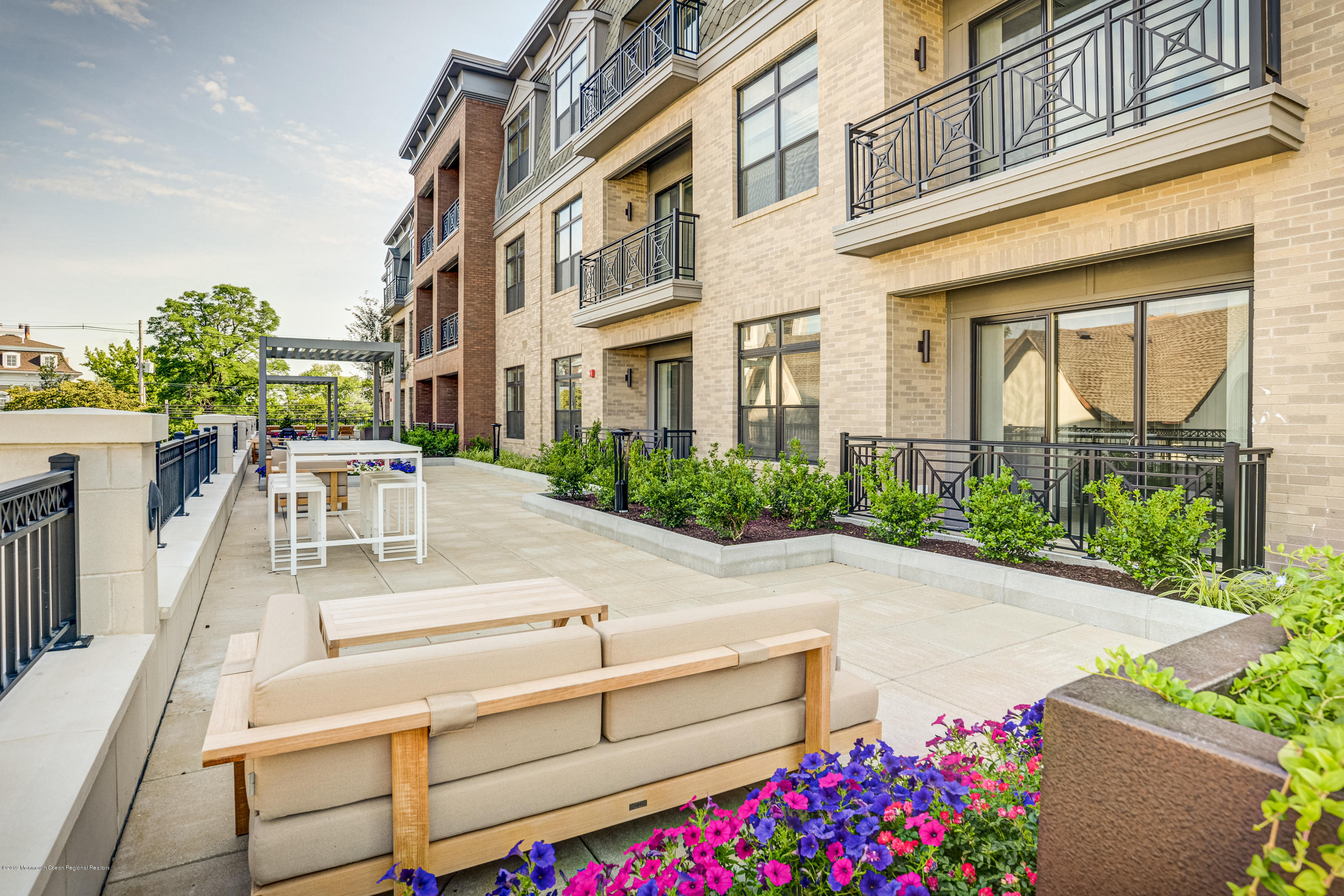 55 West Front Street, Unit 310 Red Bank, NJ 07701 - Photo 20 of 24 a view of a patio with table and chairs and potted plants