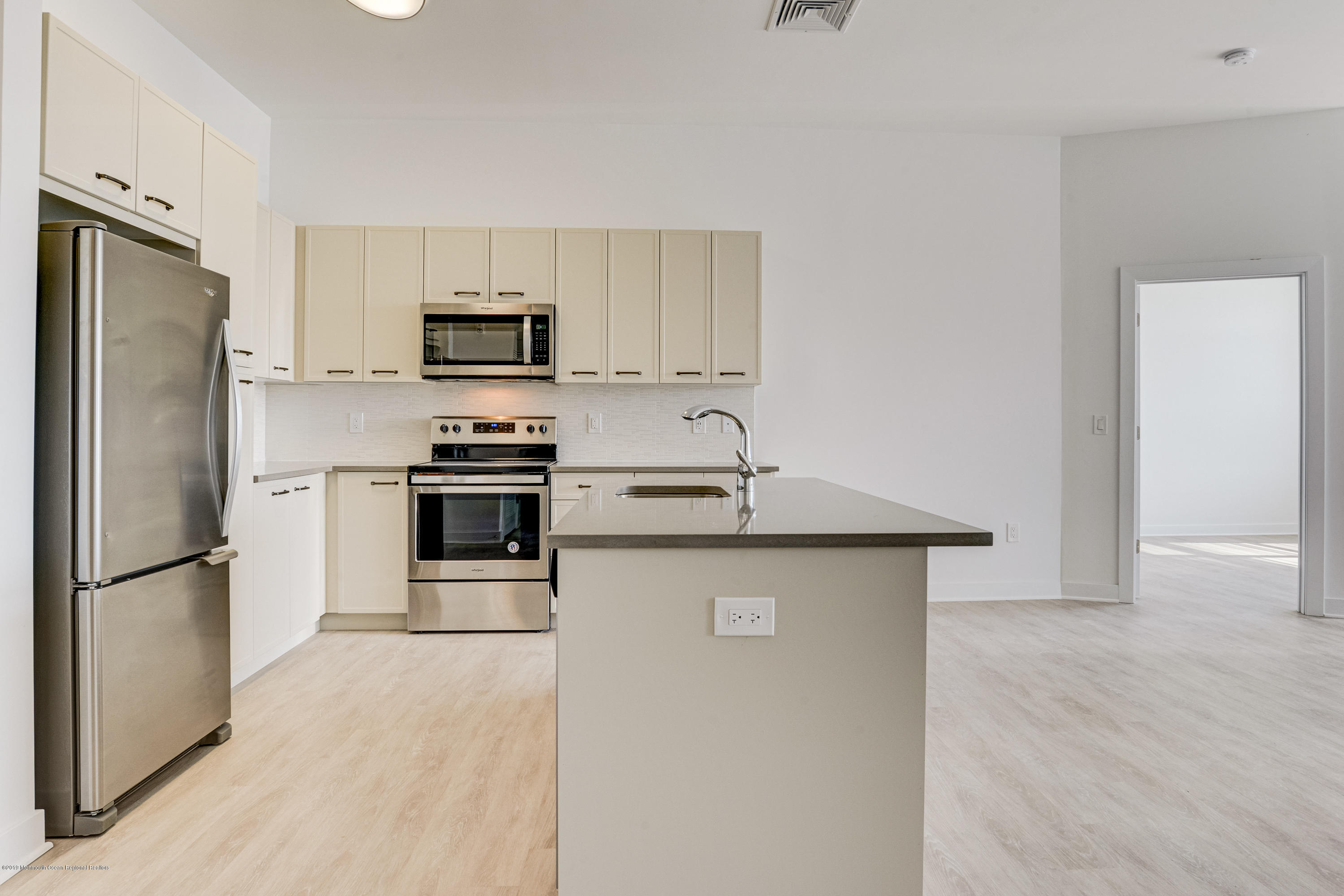 55 West Front Street, Unit 310 Red Bank, NJ 07701 - Photo 6 of 24 a kitchen with stainless steel appliances a refrigerator stove and microwave