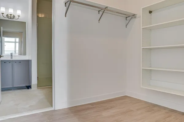 a view of walk in closet with empty racks