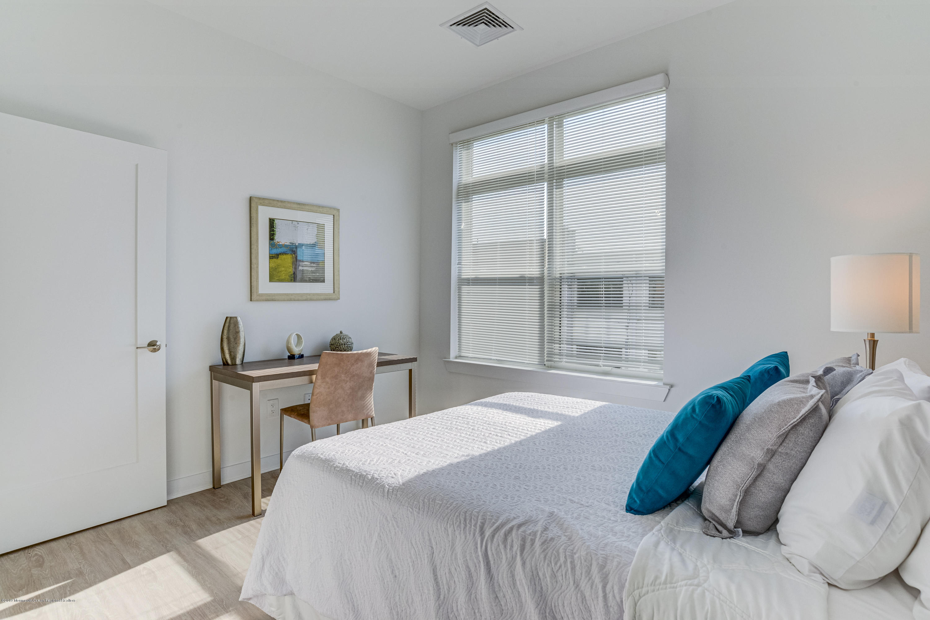 55 West Front Street, Unit 310 Red Bank, NJ 07701 - Photo 10 of 24 a bedroom with a bed and a window