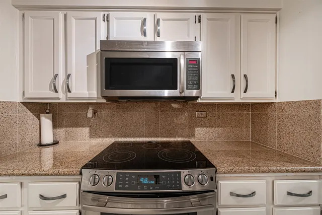 a stove top oven sitting inside of a kitchen