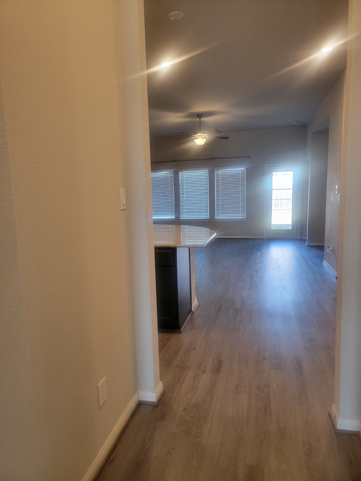 1406 Munson Valley Road Richmond, TX 77406 - Photo 5 of 27 an empty room with wooden floor and windows